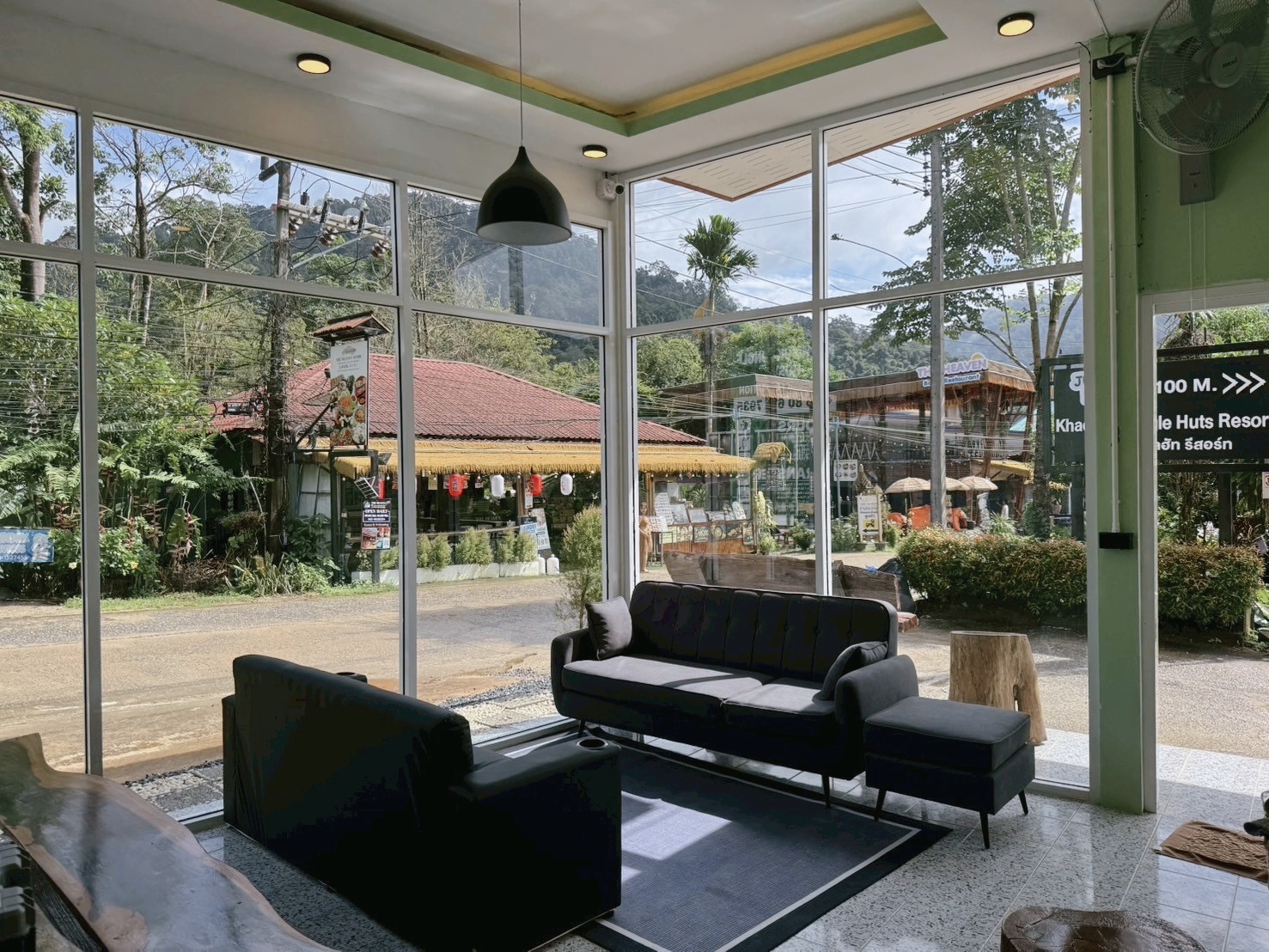 Modern hostel facilities included in Khao Sok tour packages, showing dorm room & lobby lounge area