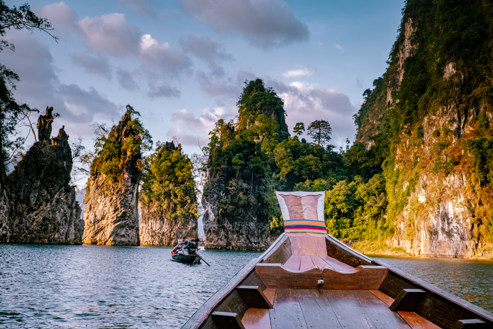 Turquoise water and karst cliffs at Cheow Lan Lake, part of Khao Sok's floating bungalow tours