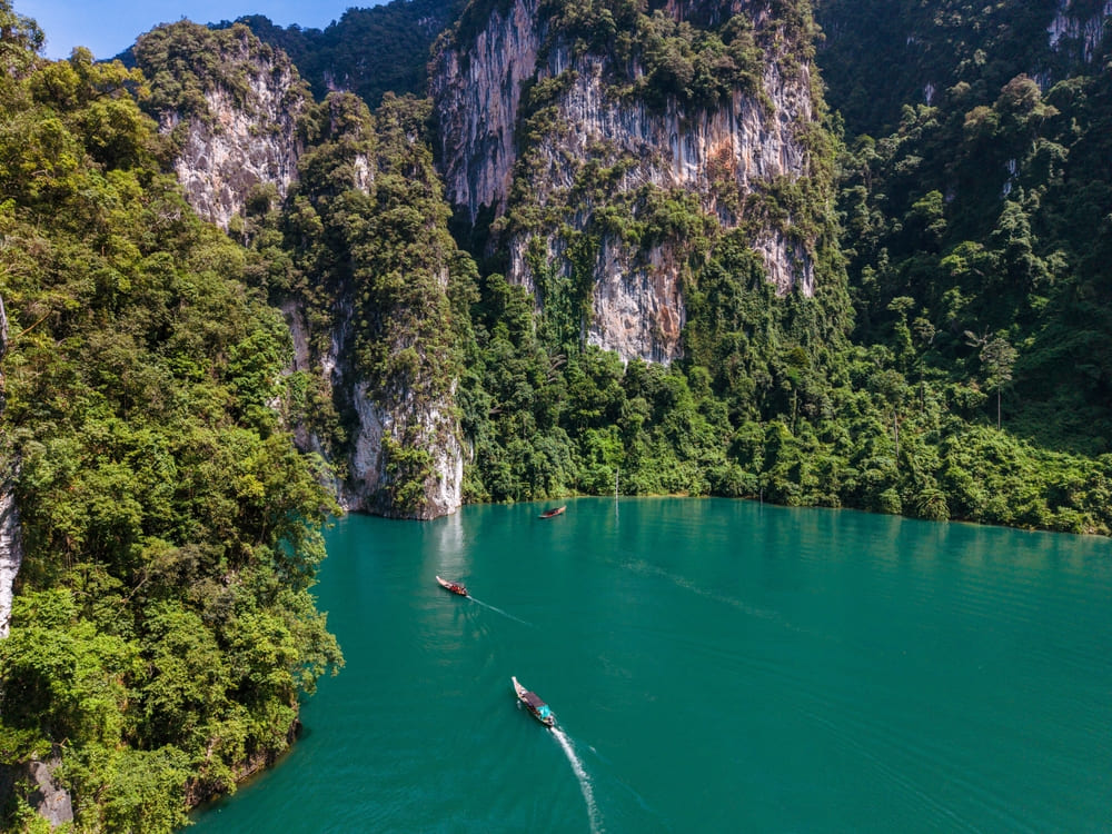 Cheow Lan Lake's turquoise water and limestone cliffs, a top Khao Sok village day trip
